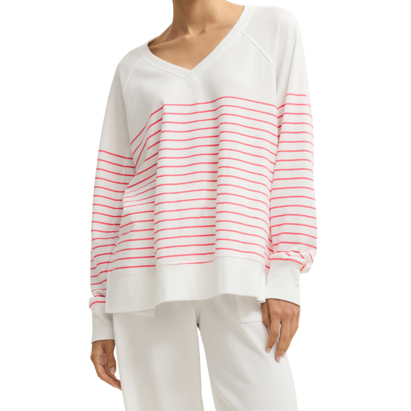 White long-sleeve top with red stripes worn by a person on a white background