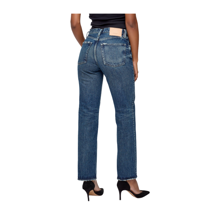 Person wearing blue jeans on a white background