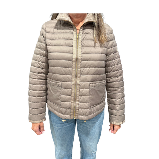 Beige puffer jacket worn by a person on a white background