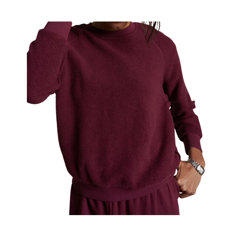 Maroon sweater worn by a person on a white background